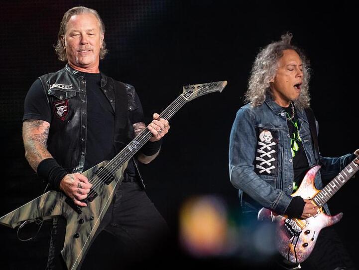 James Hetfield (l), Frontsänger der US-Metal-Band Metallica, und Kirk Hammett, Gitarrist, spielen im Olympiastadion Seite an Seite.
