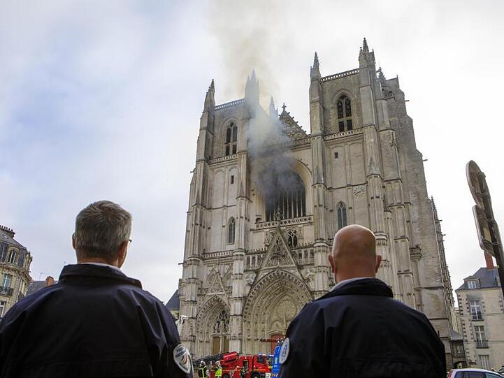 Aus einem Fenster der Kathedrale Saint-Pierre-et-Saint-Paul steigt Rauch auf.