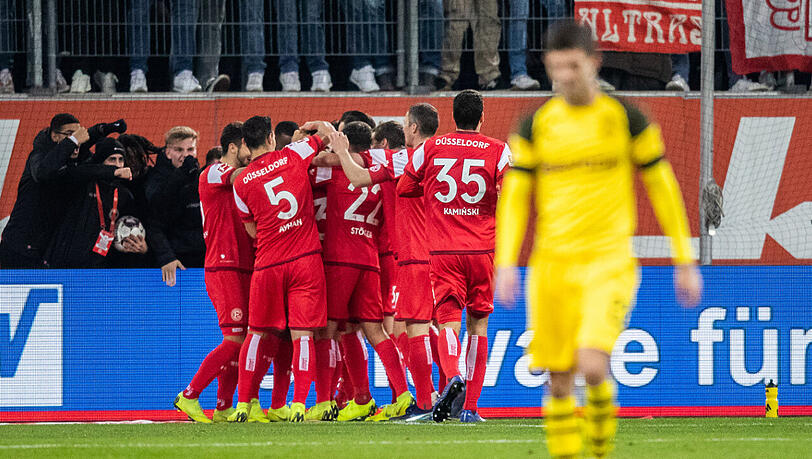 Die Düsseldorfer Spieler (hinten) freuen sich über den Treffer zum 2:0 gegen Herbstmeister Dortmund. Die Düsseldorfer Spieler (hinten) freuen sich über den Treffer zum 2:0 gegen Herbstmeister Dortmund.