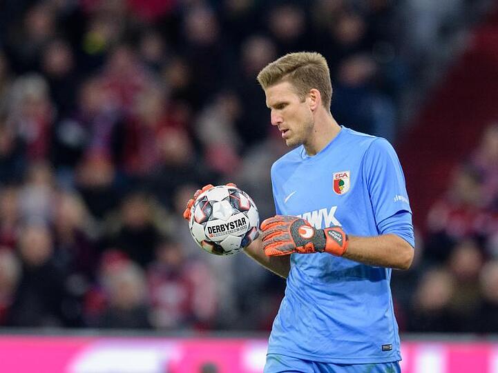 Torwart Andreas Luthe vom FC Augsburg hält den Ball in der Hand. Foto: Matthias Balk/Archiv