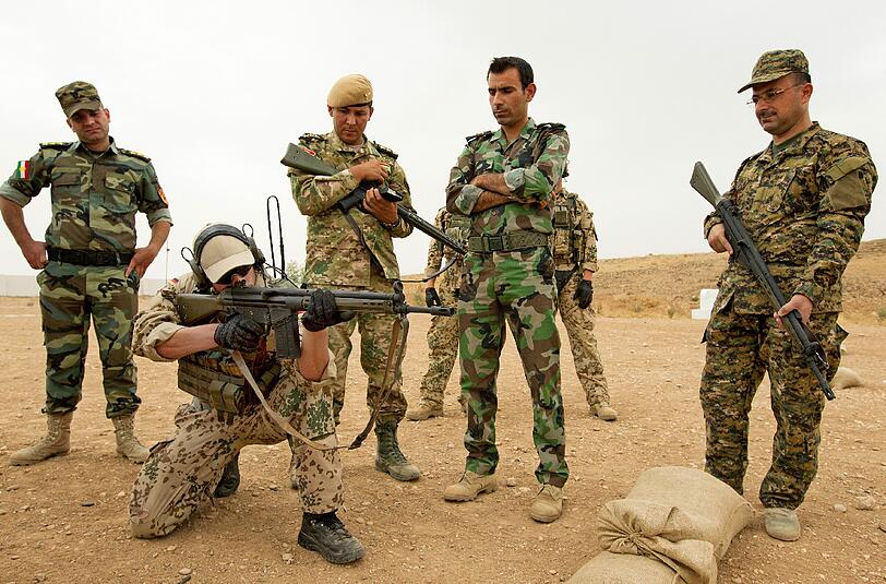 Soldaten der Bundeswehr weisen kurdische Peschmerga in die Handhabung des G3-Sturmgewehrs in Erbil ein.