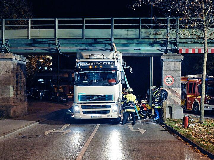 Guter Trick: Die Feuerwehr lässt einfach die Luft aus den Reifen des Lkw, so kam der Sattelzug wieder frei. Der Fahrer hatte die Höhe des Gefährts offenbar unterschätzt und war gegen eine Brücke geprallt