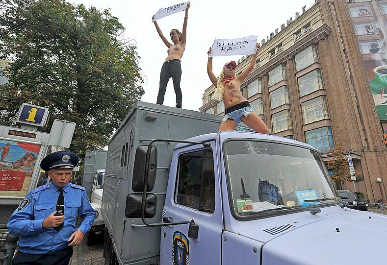 Sie sind wieder auf der Straße - die Nackt-Aktivistinnen der ukrainischen Frauenrechtsbewegung FEMEN. Hier protestierten sie publikumswirksam auf dem Dach eines Polizei-Fahrzeuges gegen die Inhaftierung von Ex-Regierungschefin Julia Timoschenko.