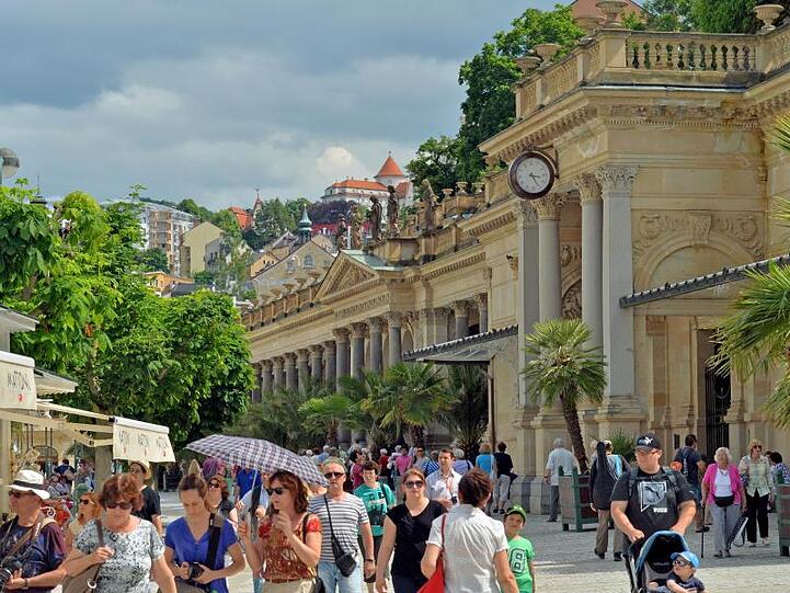 Besucher flanieren durch die Innenstadt des westböhmischen Kurorts Karlsbad. Foto: Hendrik Schmidt/Archivbild