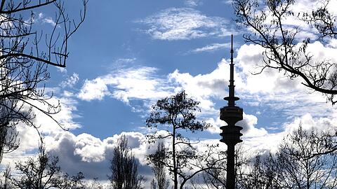 Wie ein Scherenschnitt: ein herrliches Wolkenbild mit dem Olympiaturm im Gegenlicht von der Moosacher Stra&szlig;e aus gesehen.