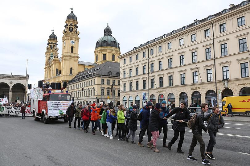 Die Demonstranten von Fridays for Future ziehen ihr Protestmobil an einem Seil an der Staatskanzlei vorbei bis zum Isartor.