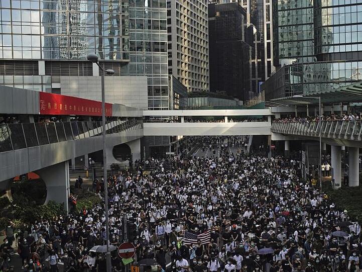Hongkongs Demonstranten marschierten vermummt durch die Stadt, bevor die Regierung ihr geplantes Vermummungsverbot durchsetzen kann.