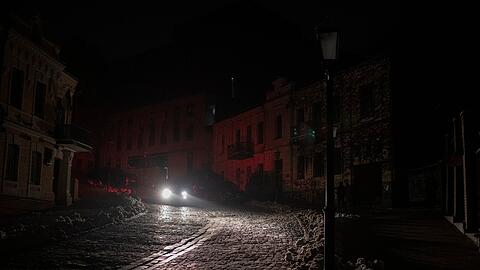 Ein Fahrzeug fährt während eines Stromausfalls nach einem russischen Raketenangriff.