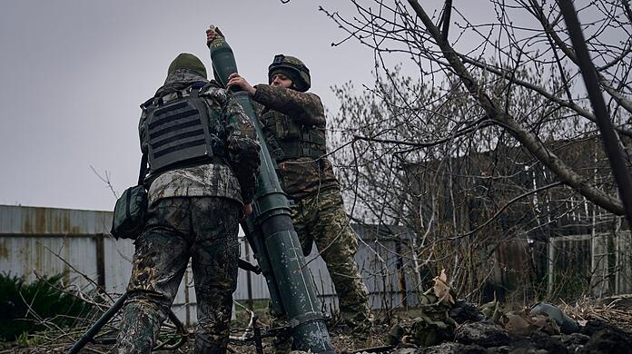 Ukrainische Soldaten feuern einen Mörser auf russische Stellungen an der Frontlinie bei Bachmut ab.