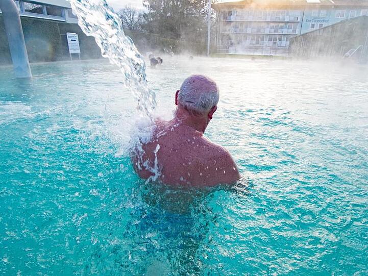 Ein Kurgast badet in einem Außenbecken der Europatherme in Bad Füssing. Foto: Armin Weigel/dpa/Archivbild