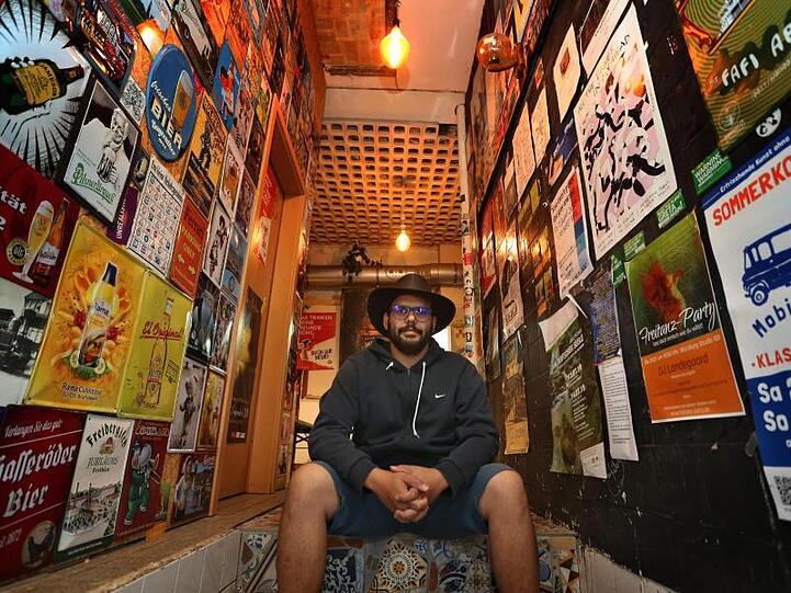 Anis Ben Hamouda, Geschäftsführer des Kiosks sitzt im Eingangsbereich seines Spätis. Foto: Karl-Josef Hildenbrand
