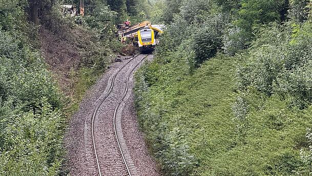 Rettungskräfte suchen in einem entgleisten Zug nach Fahrgästen. Rettungskräfte suchen in einem entgleisten Zug nach Fahrgästen.