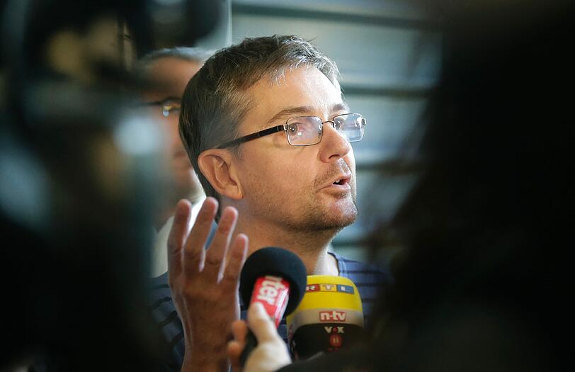 Der Zeichner und Redakteur Charb gestern in seiner Redaktion, umringt von Kamerateams. Er steht jetzt unter Polizeischutz, wie die gesamte Redaktion.