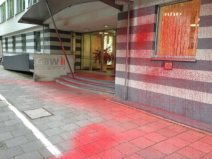 Der Eingang und auch der Bürgersteig ist rot verschmiert.