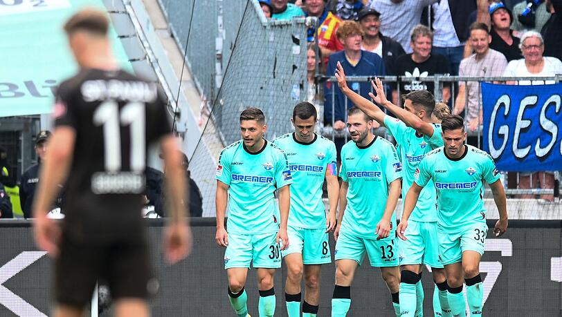Paderborns Spieler feiern ein Tor gegen den FC St. Pauli und bleiben nach dem Remis in Hamburg Tabellenführer.