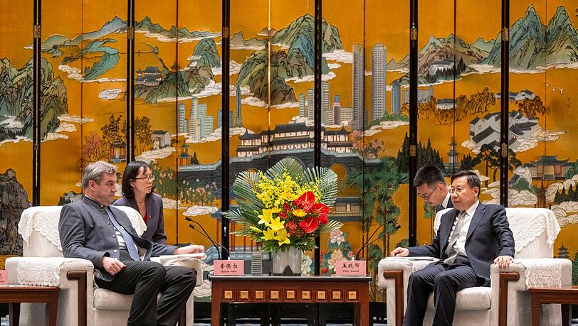 Markus Söder, (l, CSU) Ministerpräsident von Bayern, und Wang Xiaohui (r), Parteisekretär der Kommunistischen Partei, unterhalten sich.