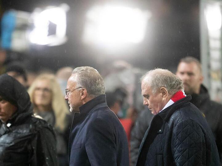 Karl-Heinz Rummenigge (l) und Präsident Uli Hoeneß gehen nach einem Spiel über den Rasen. Foto: Bernd Thissen/Archiv