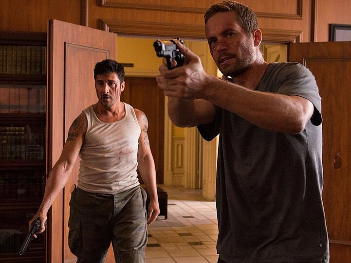 Paul Walker (r.) alias Damien Collier muss in "Brick Mansions" notgedrungen mit David Belle als Lino zusamenarbeiten