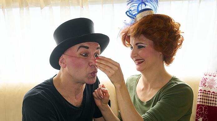 Das Clownpaar "RED and BLUE", Gennady Kantorovich (l.) und Ekaterina Mikhailova, vom "Moskauer Circus" sitzen nebeneinander. In dem Zirkus treten russische und ukrainische Artisten auf.