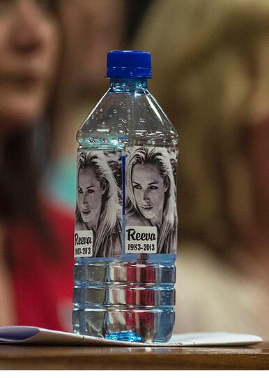 Eine Wasserflasche ist mit dem Bild von Reeva Steenkamp beklebt.