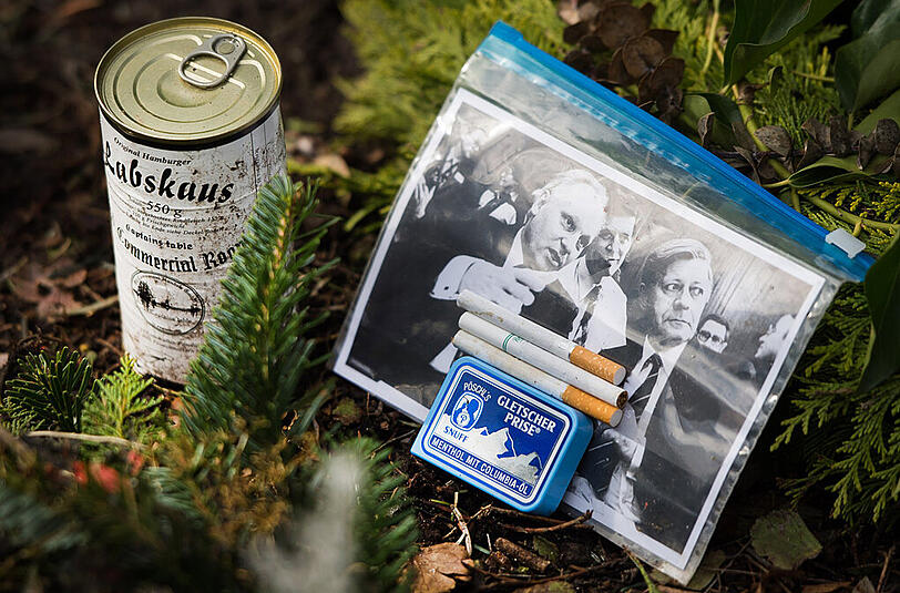 Ein Foto von Helmut Schmidt (r., links der frühere Chef der IG Bergbau und Energie, Adolf Schmidt), Zigaretten, eine Schachtel Schnupftabak und eine Dose Labskaus am Grab des ehemaligen Bundeskanzlers.