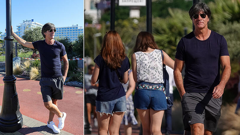 Lässig, lässiger, Löw: Der Bundestrainer lehnt entspannt an einem Laternenpfahl an der Strandpromenade vor dem deutschen Teamhotel in Sotschi