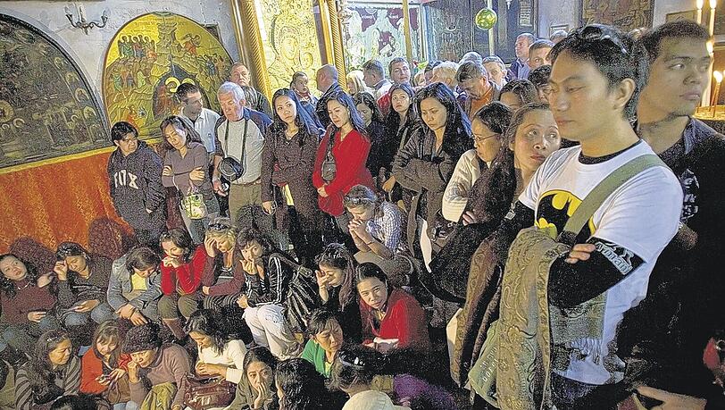 Dicht gedrängt sitzen die Touristen in der Geburtskirche in Bethlehem. Die Hotels in Bethlehem sind bis weit in den Januar hinein ausgebucht. Foto: AP Dicht gedrängt sitzen die Touristen in der Geburtskirche in Bethlehem. Die Hotels in Bethlehem sind bis weit in den Januar hinein ausgebucht. Foto: AP