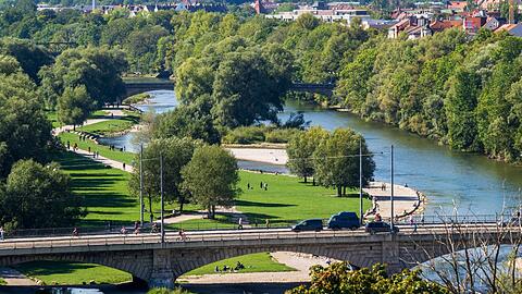 An der Isar entspannen viele Münchner. Trotzdem ist eine Uferseite von Autos geprägt.