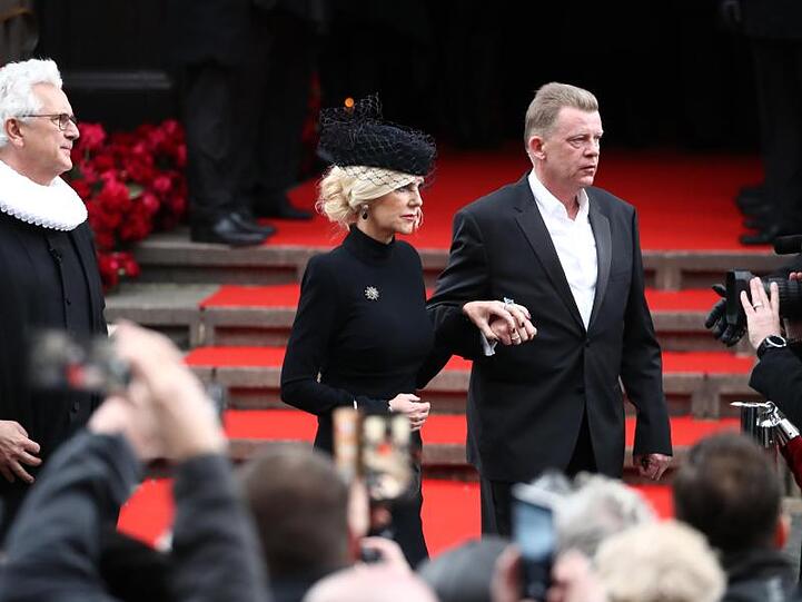Die Witwe des Schauspielers Jan Fedder, Marion Fedder, wird nach der Trauerfeier von Joerg Pawlik (r) , dem Produktionsleiter des "Großstadtreviers", aus der Kirche begleitet. Neben ihnen steht Pastor Alexander Röder.
