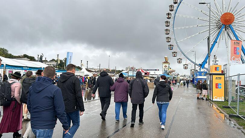Einige Besucher haben ihre Trachtenjacke durch eine Regenjacke ausgetauscht an diesem letzten Wiesn-Wochenende.