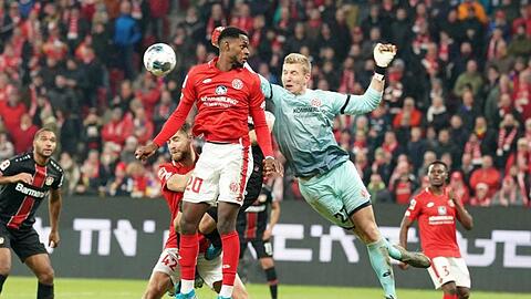 Der Mainzer Torwart Robin Zentner (r) und Edimilson Fernandes (M) wehren einen Angriff ab.