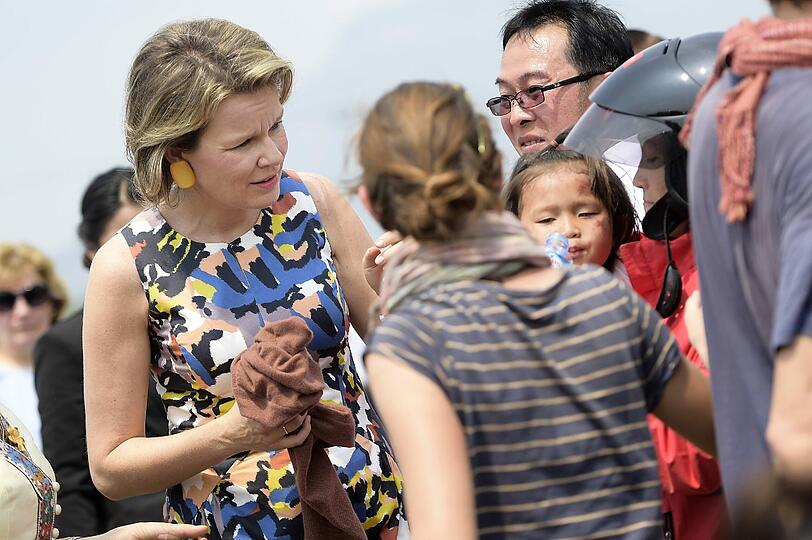 Königin Mathilde spricht mit Menschen, die in einen Verkehrsunfall verwickelt waren