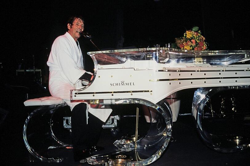 Legende sind sowohl Udo Jürgens' Zugaben im weißen Bademantel als auch sein durchsichtiger Konzertflügel. Hier ist der Star 1997 bei einer Zugabe zu sehen.