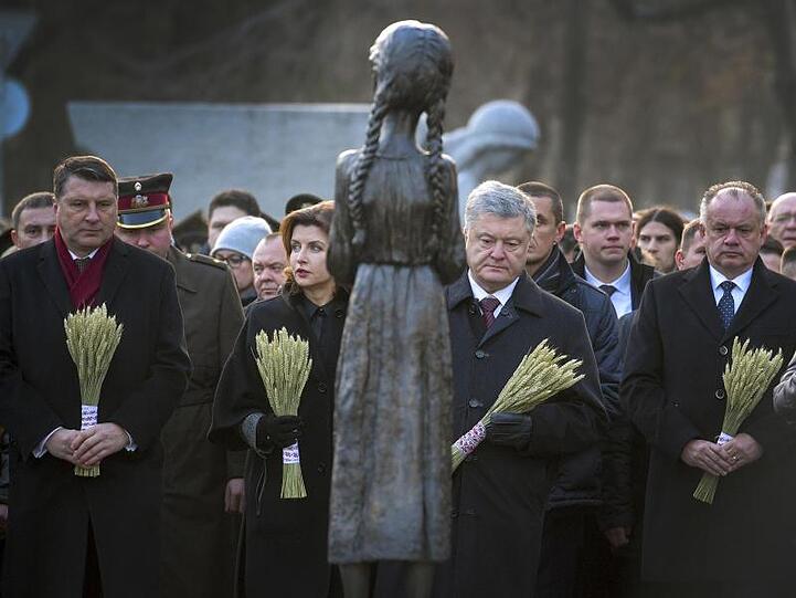 Der ukrainische Präsident Petro Poroschenko nimmt zusammen mit seiner Frau Marina sowie seinen Amtskollegen aus Lettland, Raimonds Vejonis (l), und der Slowakei, Andrej Kiska (r), in Kiew an einer Gedenkveranstaltung zur Hungersnot vor 86 Jahren teil.