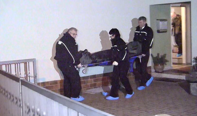 Mitarbeiter der Polizei transportieren die Leiche der 21-Jährigen ab.