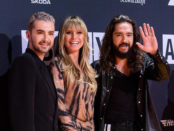 Bill (l.) und Tom Kaulitz (r.) mit Heidi Klum. Foto: Matthias Balk
