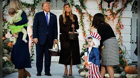 Melania und Donald Trump begr&uuml;&szlig;en verkleidete Kinder auf dem S&uuml;drasen des Wei&szlig;en Hauses.