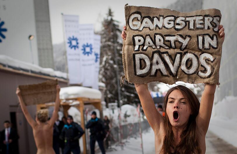 Nacktprotest in Davos: Ukrainerinnen demonstrieren barbusig am Zaun vor dem Weltwirtschaftsforum. Die Polizei greift ein - die Bilder.