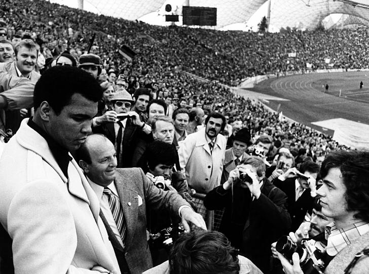 Ali - hier beim Viertelfinale der Fußball-Europameisterschaft 1976 zwischen Deutschland und Spanien auf der Tribüne des Olympiastadions - ist bis heute einer der größten Sportler des Jahrhunderts und noch immer bekannt für seine markigen Sprüche...