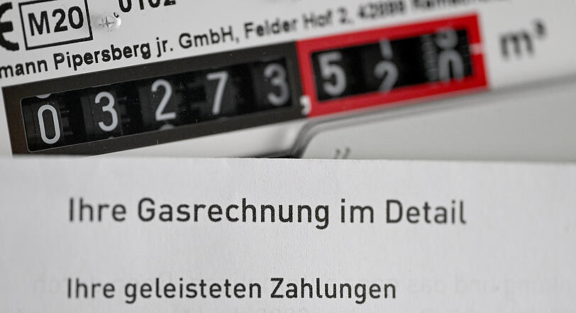 Eine Gasrechnung wird vor einen Gaszähler in einem privaten Haushalt gehalten. (Symbolbild)