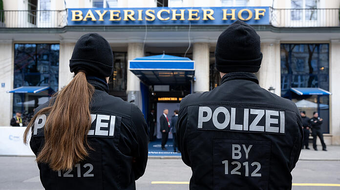 Polizisten stehen vor Beginn der Sicherheitskonferenz vor dem Hotel Bayerischer Hof. Zur 60. Münchner Sicherheitskonferenz im Hotel Bayerischer Hof werden von Freitag bis Sonntag rund 50 Staats- und Regierungschefs sowie mehr als 100 Minister aus aller Welt erwartet.