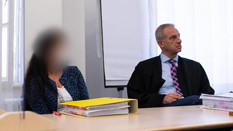 Eine angeklagte Heilpraktikerin sitzt zusammen mit ihrem Anwalt Thomas Behrmann im Sitzungssaal auf ihrem Platz.