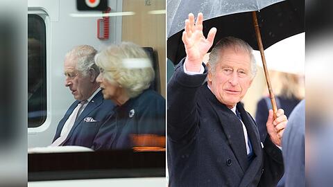 König Charles und Camilla haben es sich im ICE gemütlich gemacht. Bei der Ankunft in Hamburg war dann der Regenschirm gefragt.