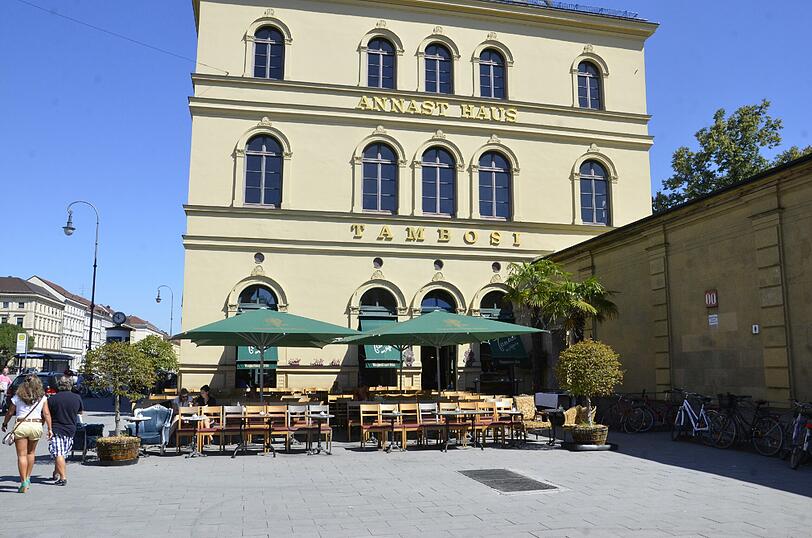 Was ist denn hier los? Sonst ist das Tambosi am Odeonsplatz voll besetzt. Heute bleiben die Gäste tagsüber aus. Woran das liegt, zeigt das Thermometer: Fast 38 Grad sind es. 
Die umstehenden Häuser und Mauern halten den Wind fern. Kein Lüftchen weht. Die Hitze staut sich.
Nur vier Gäste haben sich an die Tische verirrt und verstecken sich &ndash; natürlich &ndash; im Schatten. Hier scheint heute wirklich einer der heißesten Plätze Münchens zu sein.