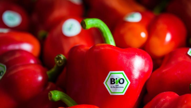 Rote Paprika mit Bio-Siegel liegen am Stand von Demeter auf der BioFach-Messe.