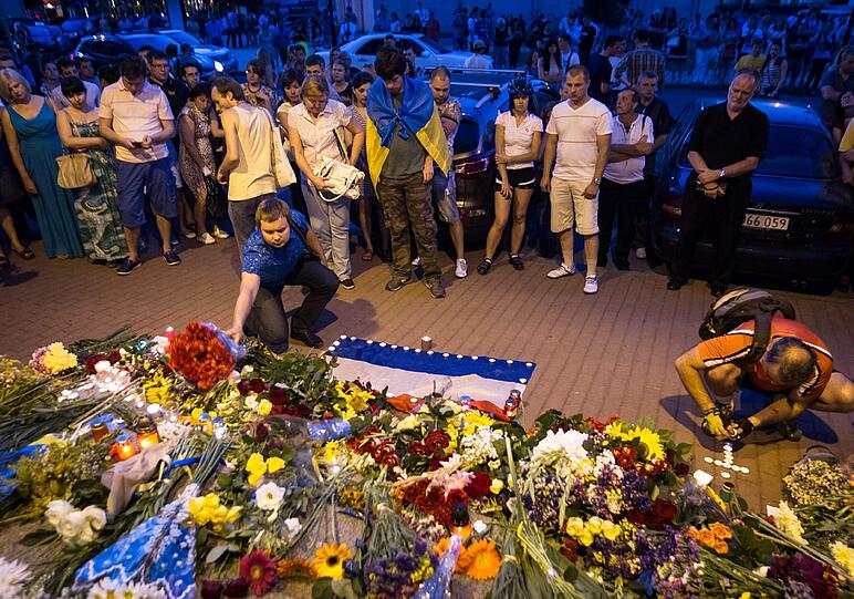 Vor der niederländischen Botschaft in Kiew legen Menschen Blumen nieder und gedenken der Opfer.