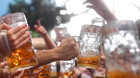 Wiesn-Besucher prosten sich gegenseitig zu. Foto: Tobias Hase/Archivbild