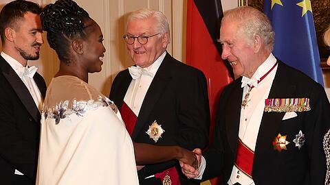Motsi Mabuse gibt König Charles III. beim Staatsbankett im Berliner Schloss Bellevue die Hand.