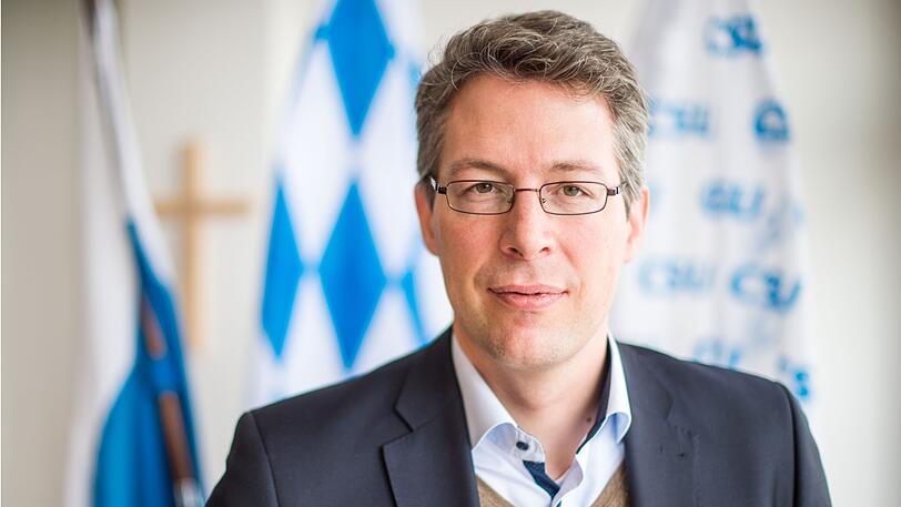 Bayern, München: Markus Blume (CSU), Generalsekretär der CSU, steht in einem Besprechungsraum in der CSU Landesleitung vor Fahnen der CSU.