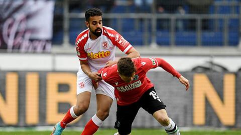 Hannovers Dominik Kaiser (r) und der Regensburger Sarpreet Singh im Zweikampf.